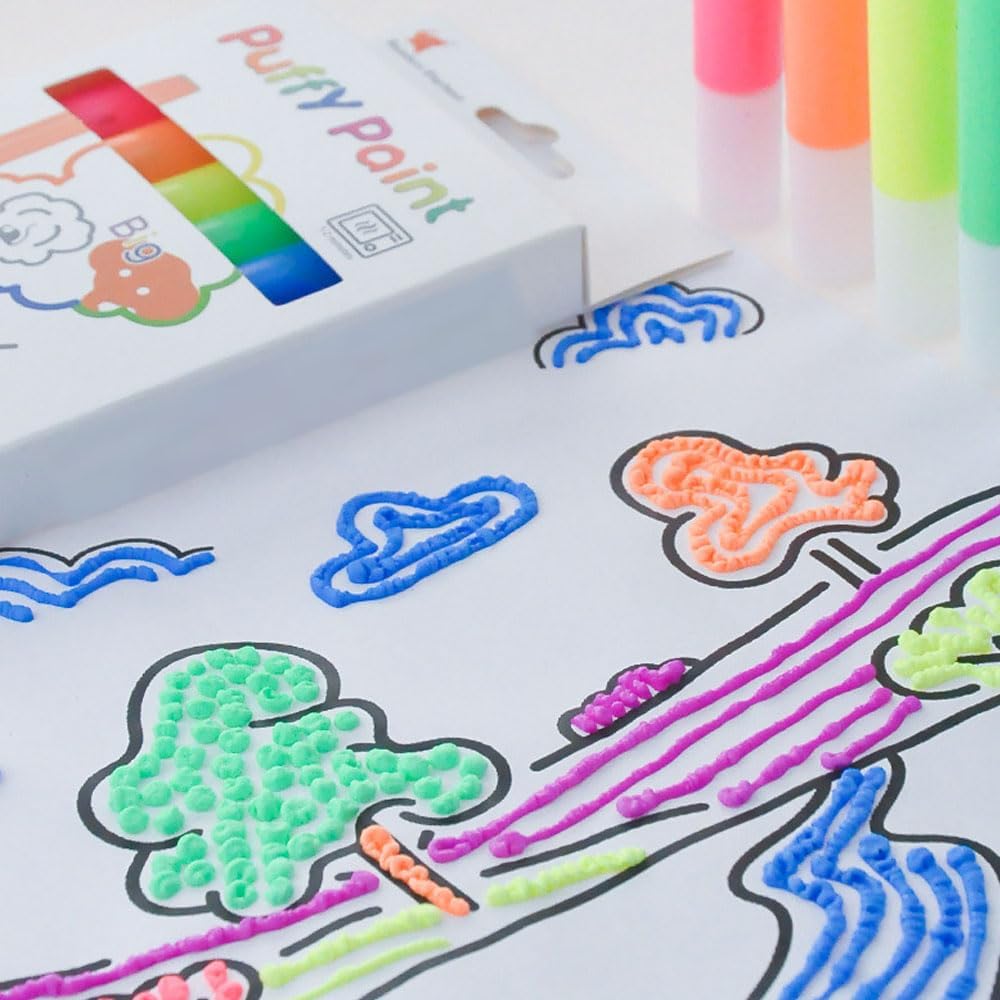 Colorful putty paint kit with a sample design on paper