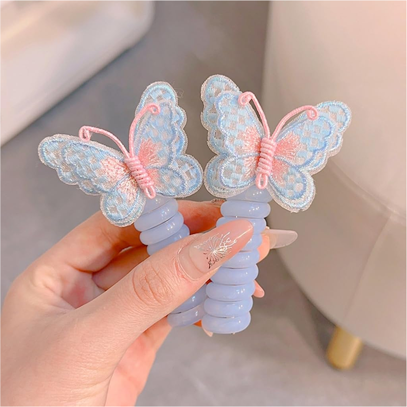 Two pink and yellow butterfly charm hair ties on a white background