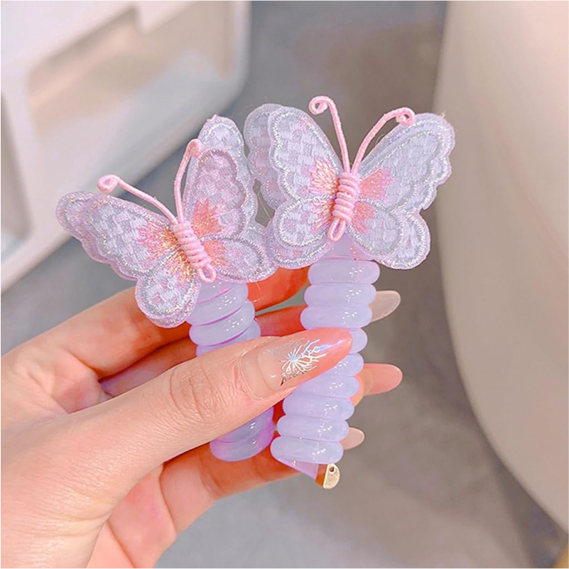 Two pink and yellow butterfly charm hair ties on a white background